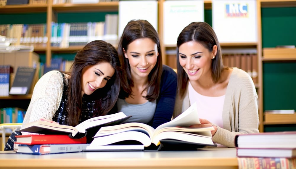 People studying English together with MC Academy books